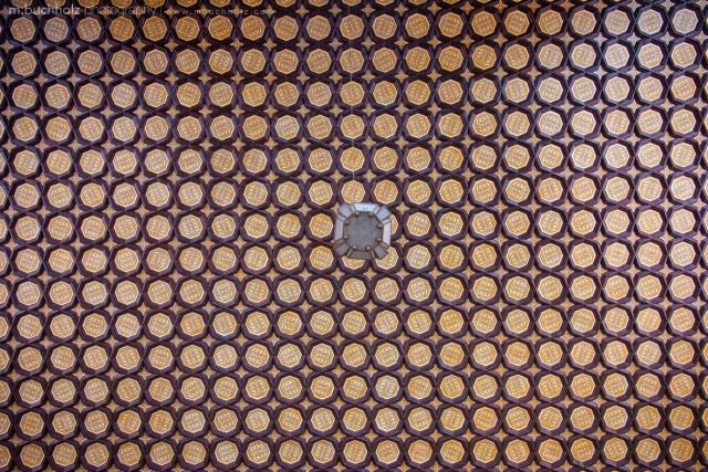 Hexagonal tiles form patterns across the ceiling of Plaza de España in Seville, Andalucia.