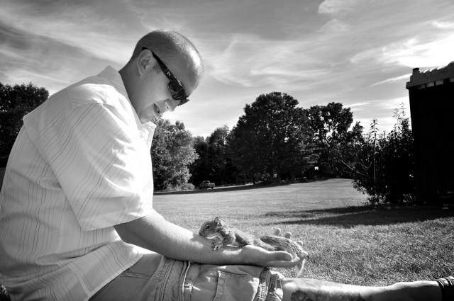 Baby Squirrel Climbing Up A Man's Arm