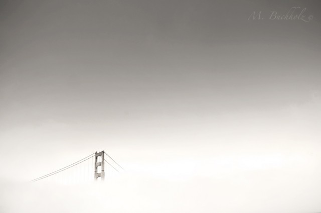 Golden Gate Bridge in fog; San Francisco, California